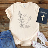 a t - shirt with a picture of a woman's face and a bible