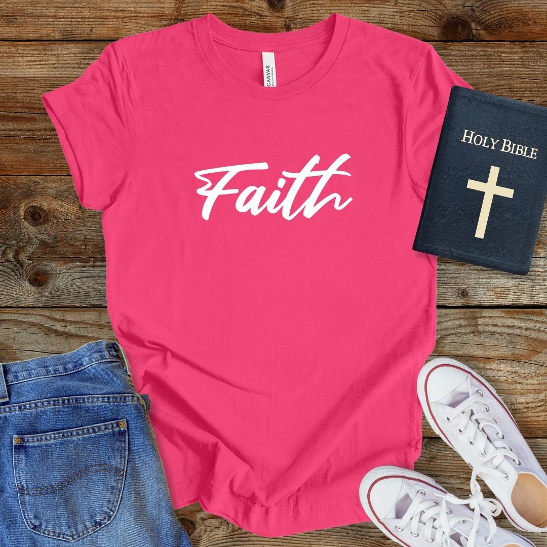 a t - shirt that says faith with a bible next to it