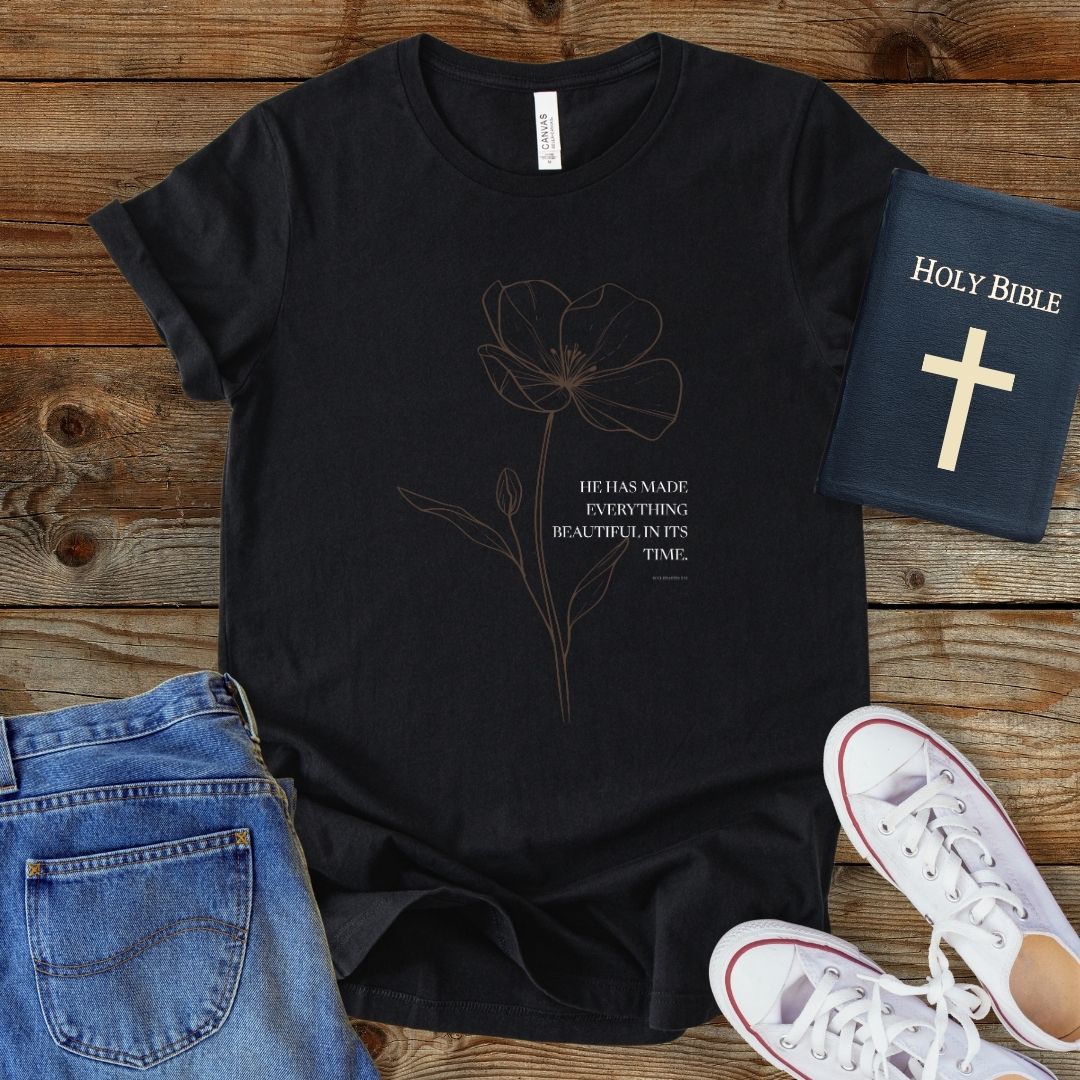 a black t - shirt with a picture of a flower on it