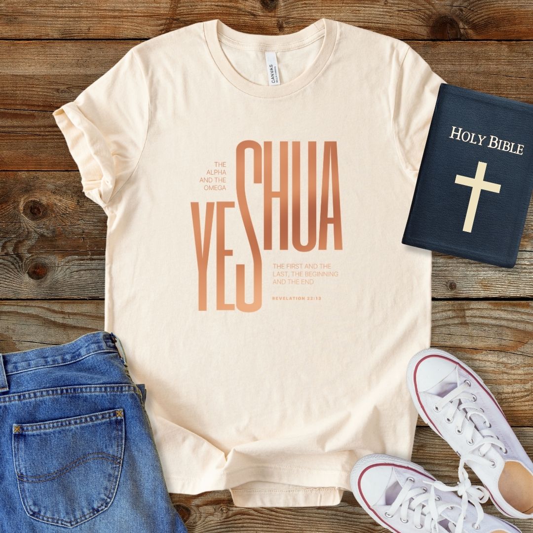 a t - shirt with the words yeshua on it next to a pair of