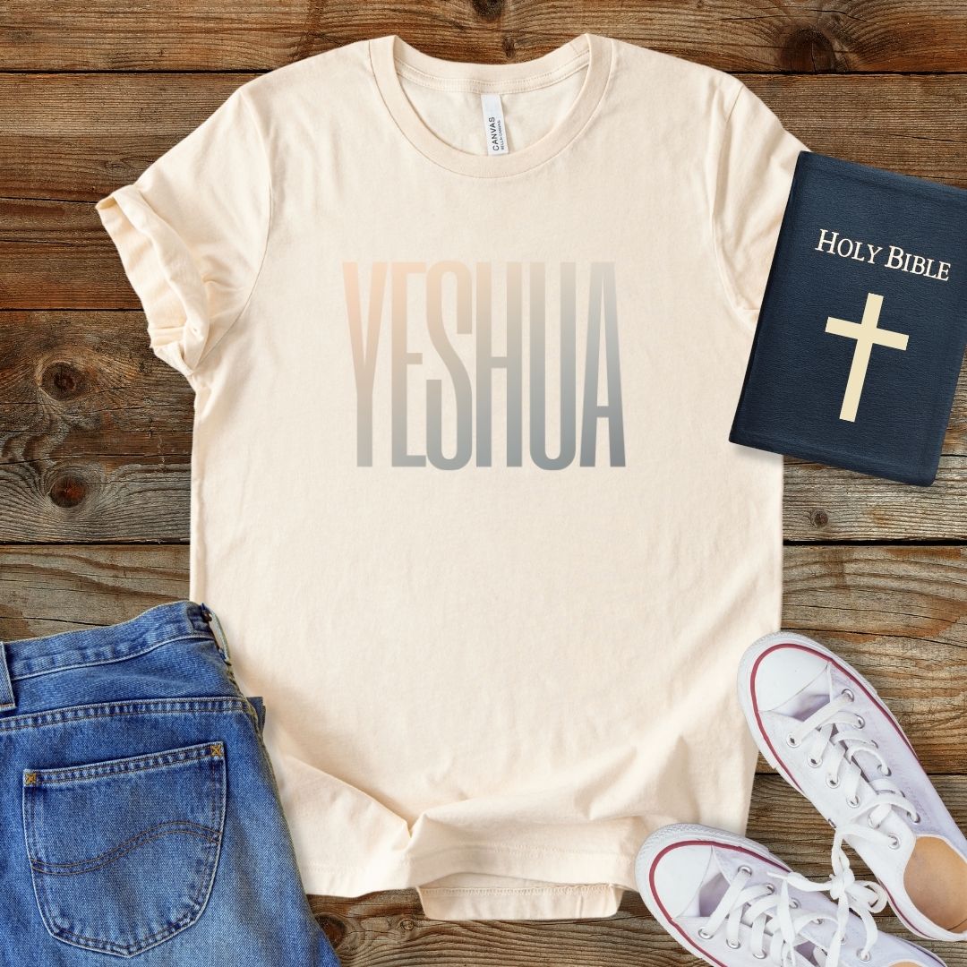 a t - shirt that says yeshuaa with a bible next to it