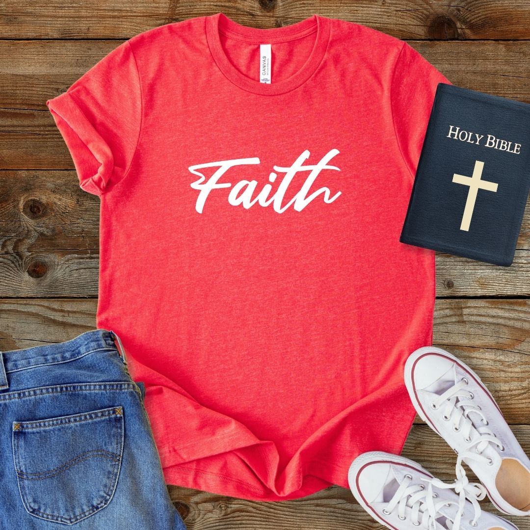 a t - shirt that says faith next to a pair of jeans