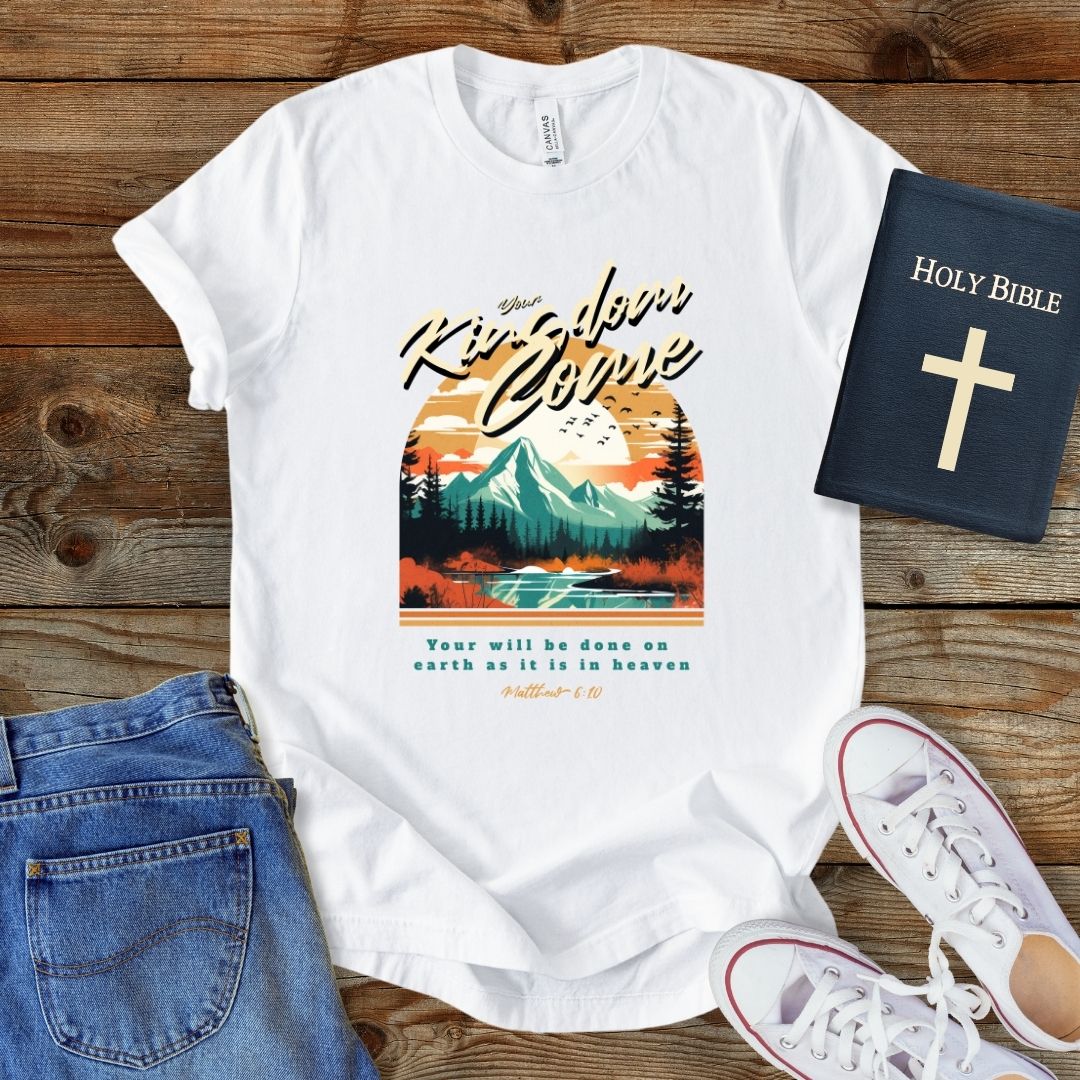 a white t - shirt with a mountain scene on it
