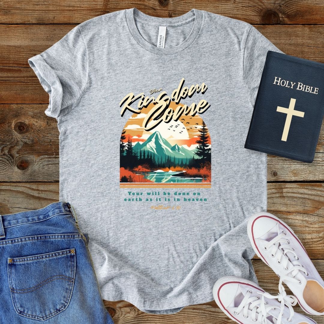 a grey t - shirt with a mountain scene on it