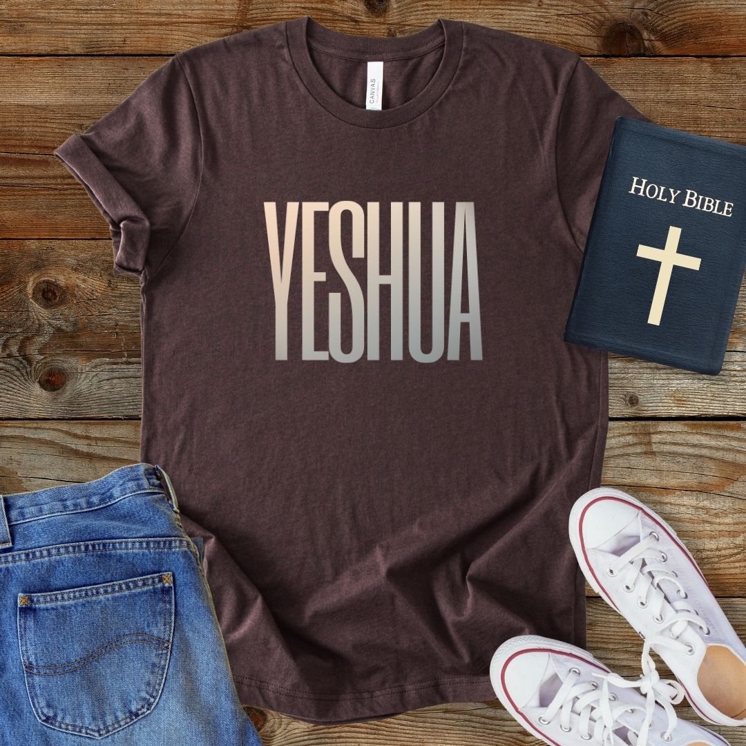 a t - shirt that says yeshuaa next to a pair of jeans and