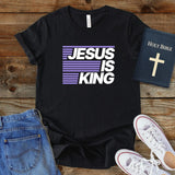 a t - shirt that says jesus is king next to a pair of jeans and