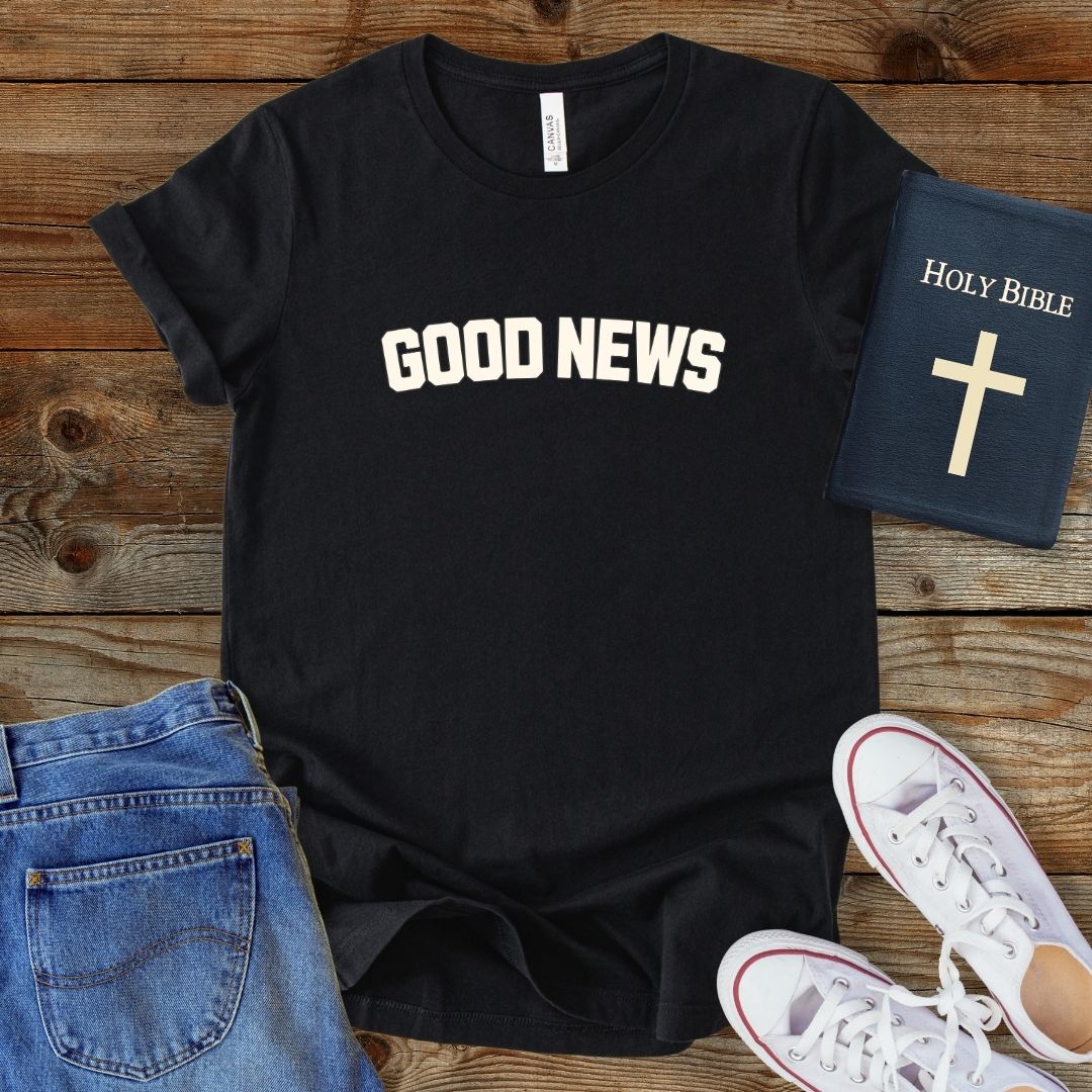 a t - shirt that says good news next to a pair of jeans