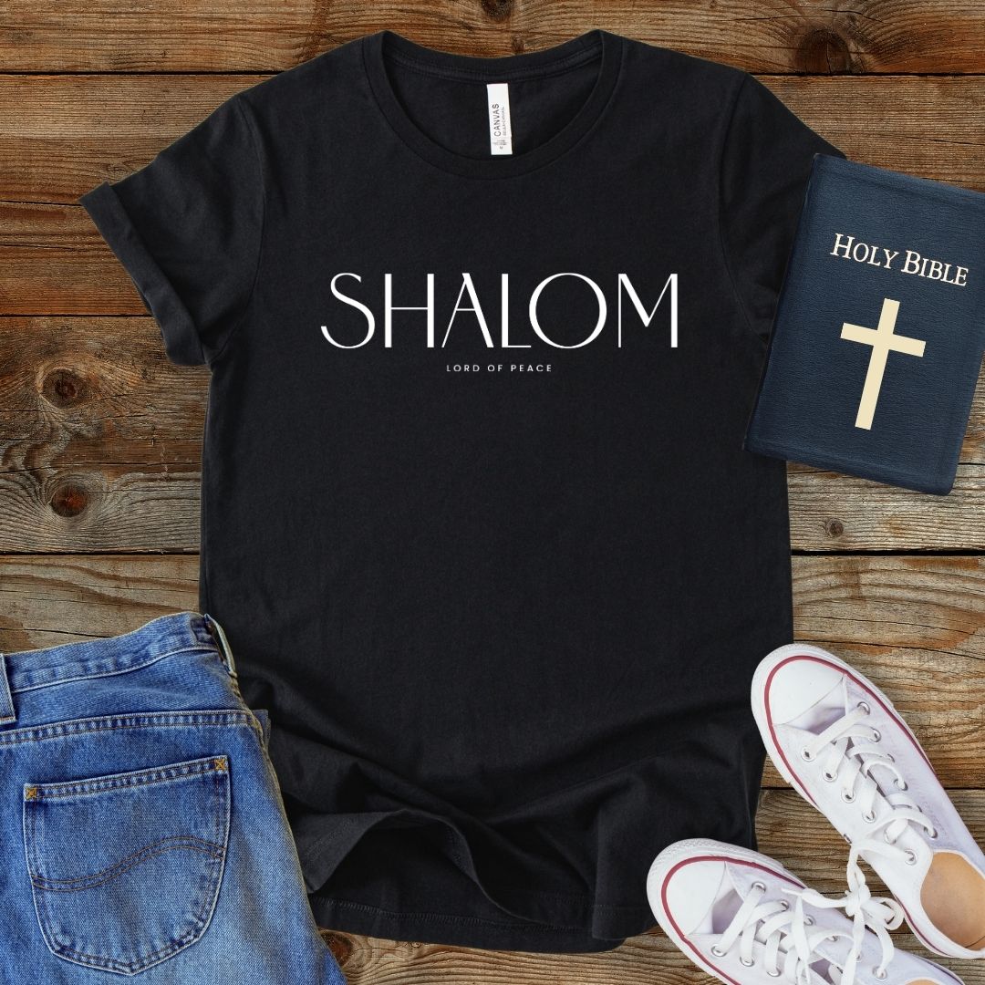a t - shirt with the word shaom on it next to a pair of