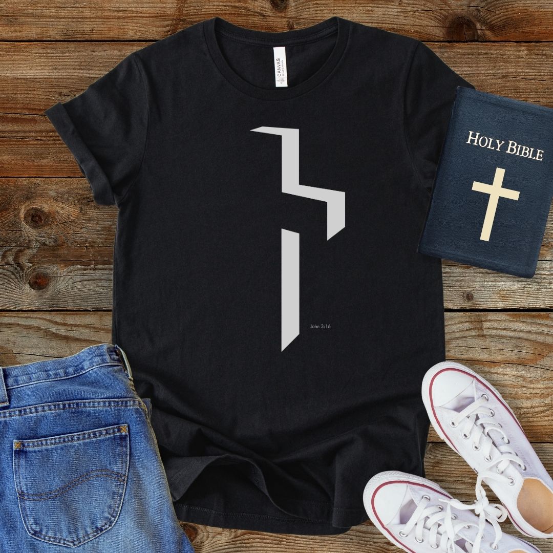 a t - shirt with a cross on it next to a pair of jeans