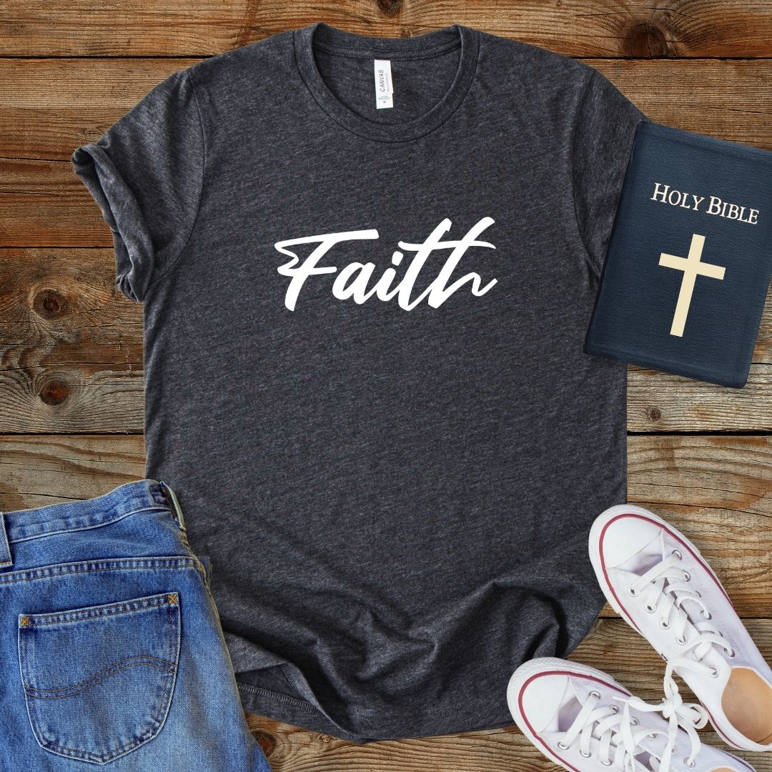 a t - shirt with the word faith on it next to a pair of jeans