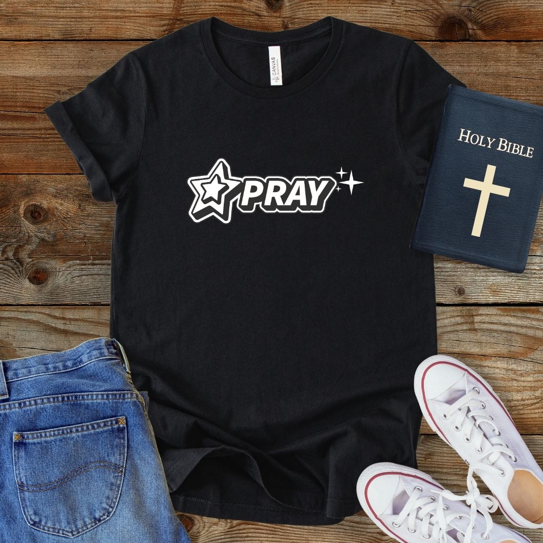 a t - shirt with the word pray and a cross on it