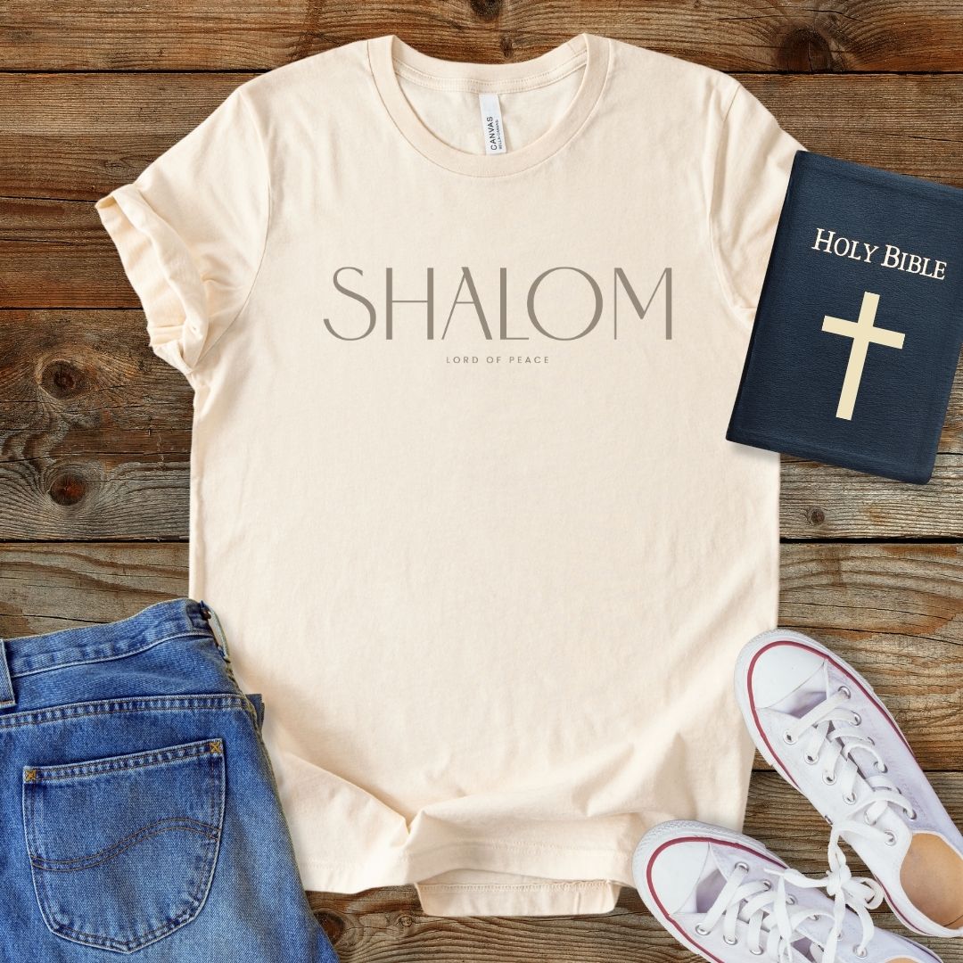 a t - shirt with the word shaiom on it next to a pair of