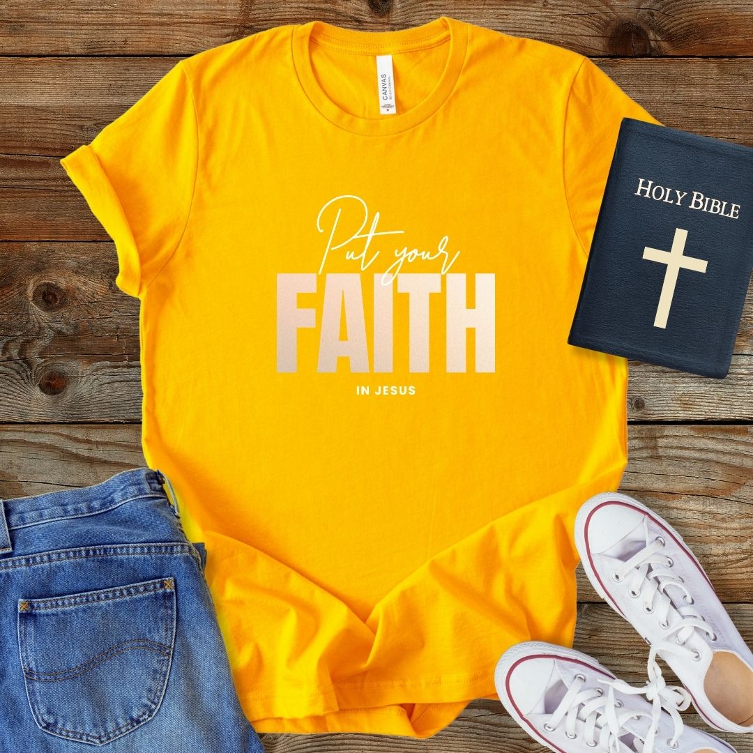 a t - shirt with the words, pray, and a bible next to it