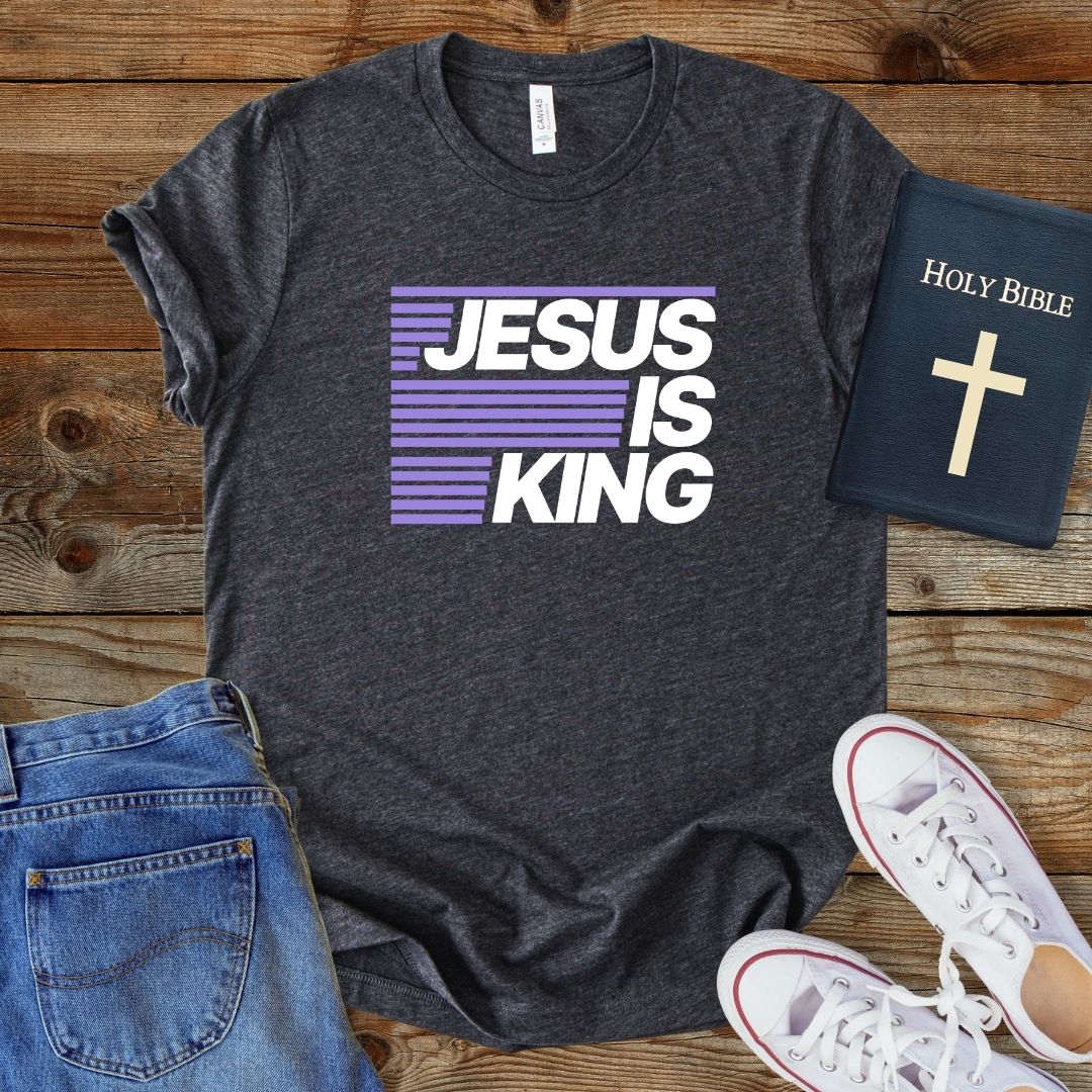 a t - shirt that says jesus is king next to a bible