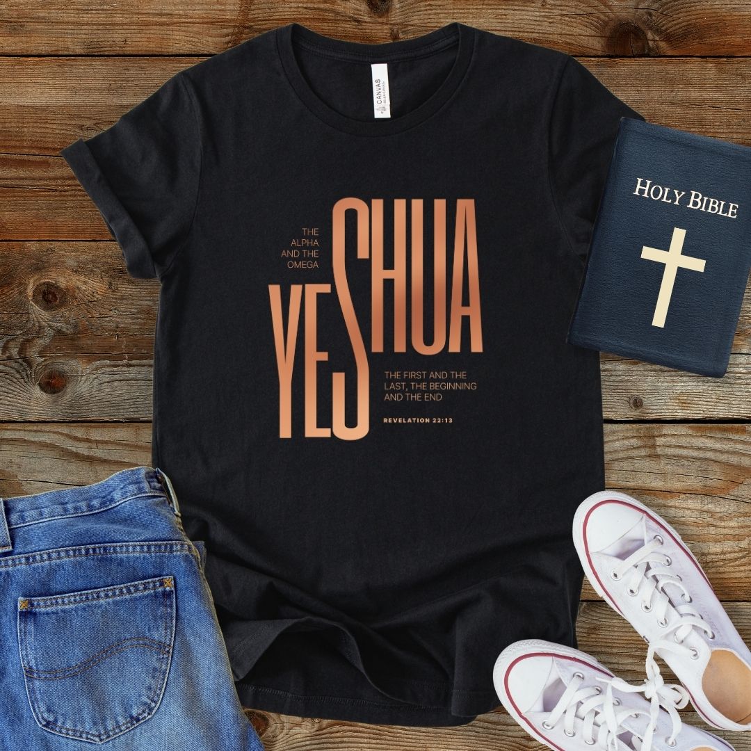 a t - shirt with the words yeshua on it next to a pair of
