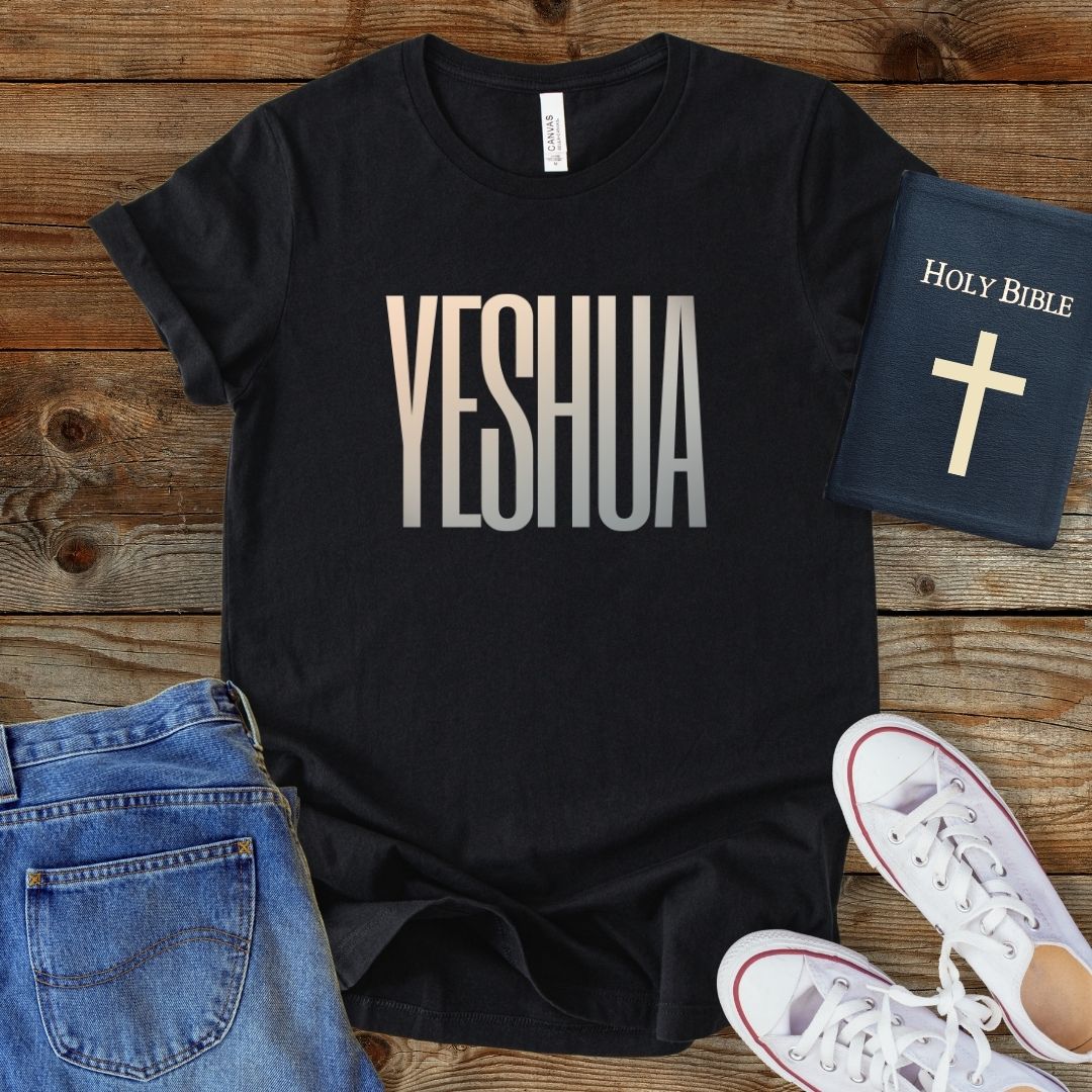 a t - shirt that says yeshuaa next to a pair of jeans and
