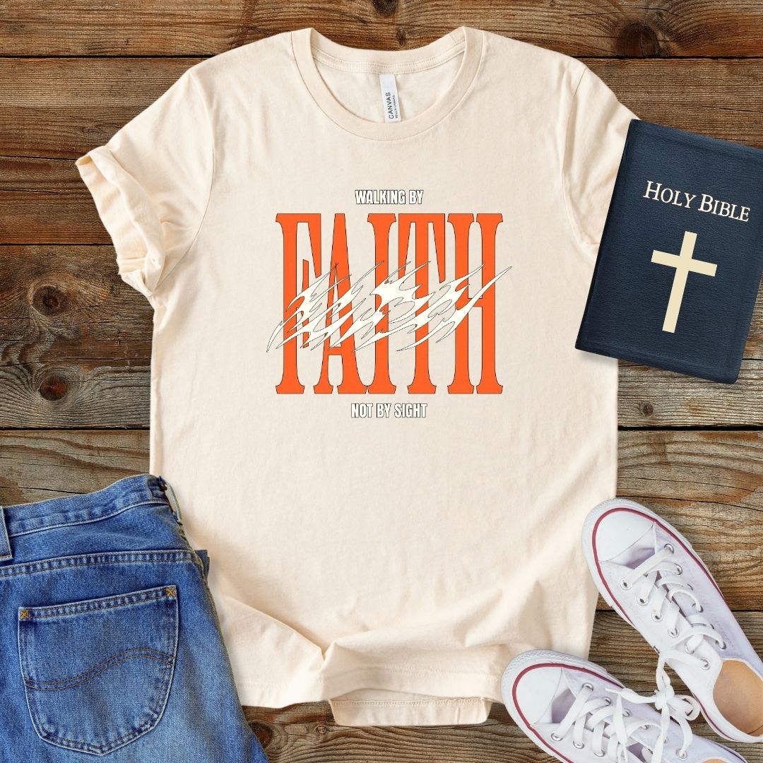 a t - shirt with the word faith on it next to a pair of jeans