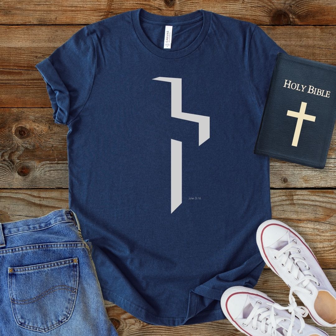 a t - shirt with a cross and a bible next to it
