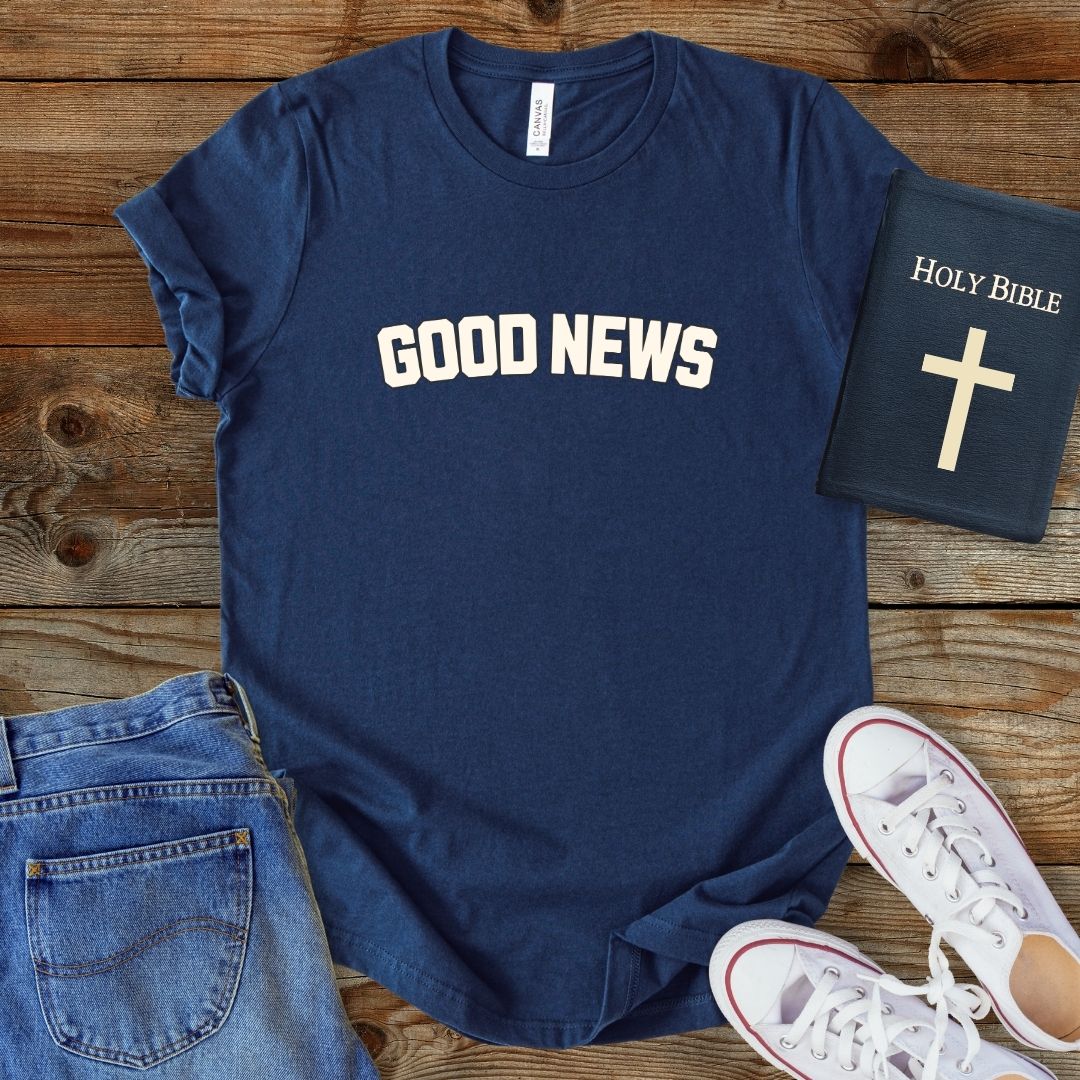 a t - shirt that says good news next to a pair of jeans