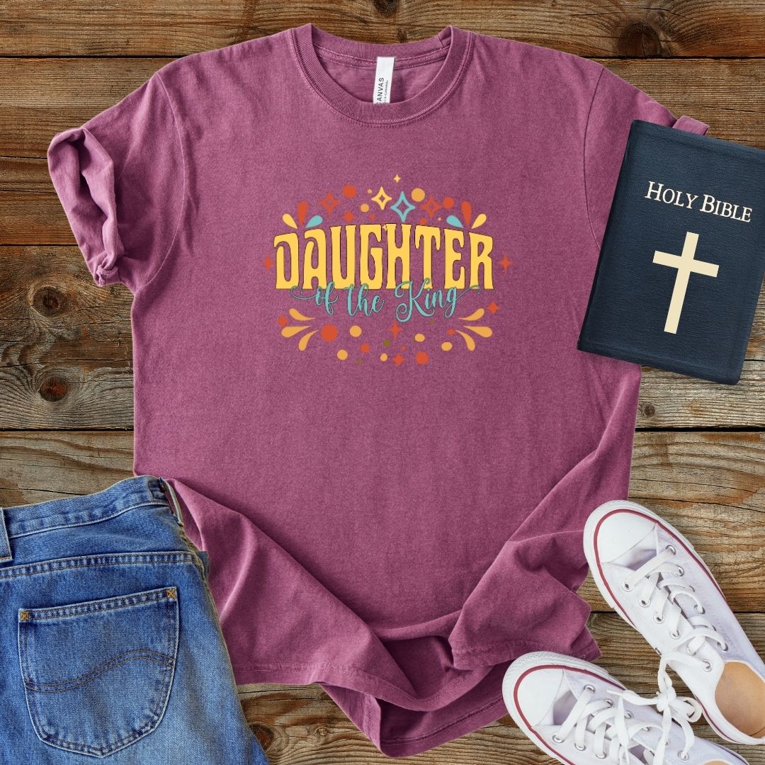 a women's t - shirt with a bible next to it